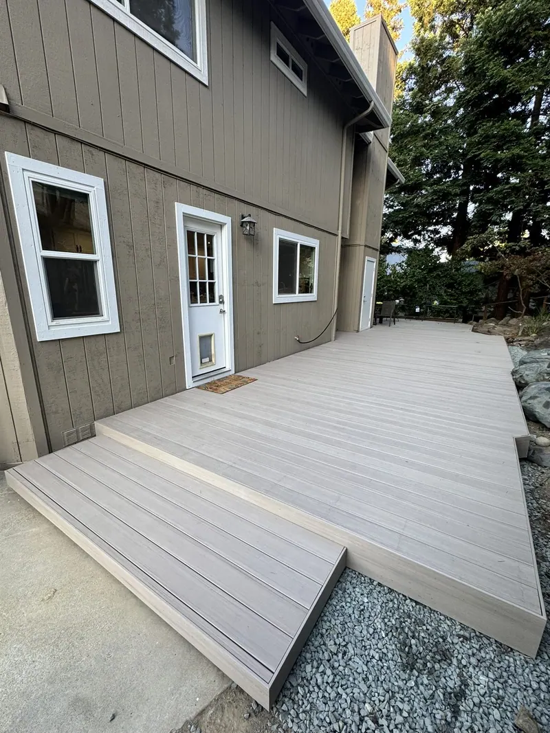 New composite deck along the back of a house