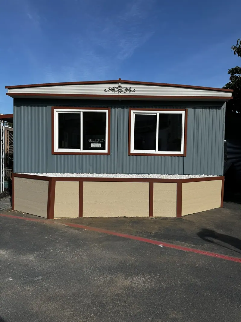 Manufactured home with new skirting, trim and terracotta steps