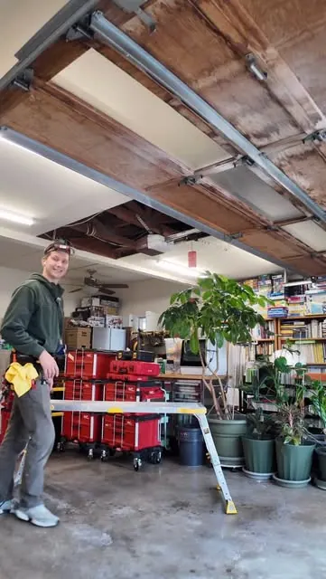 Aleksei Kasatkin, owner of ORCA Build Group, in a client garage with his tools